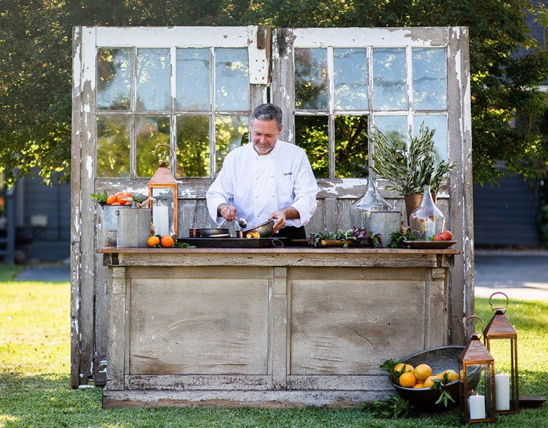 Chef cooking at chef's bar outdoor event at The Kitchen for Exploring Foods